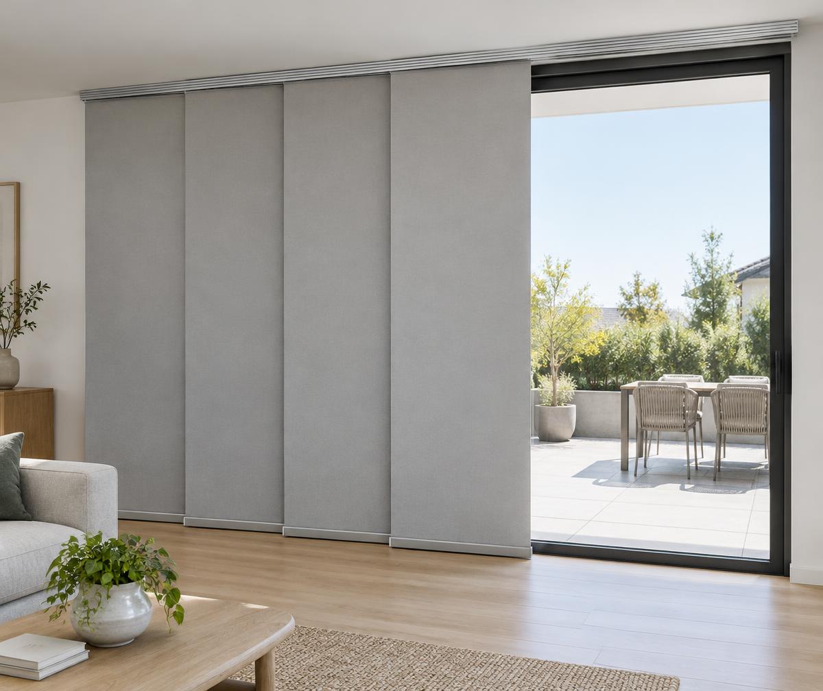 Illustrative broad panel glide blinds stacked beside a sliding patio door